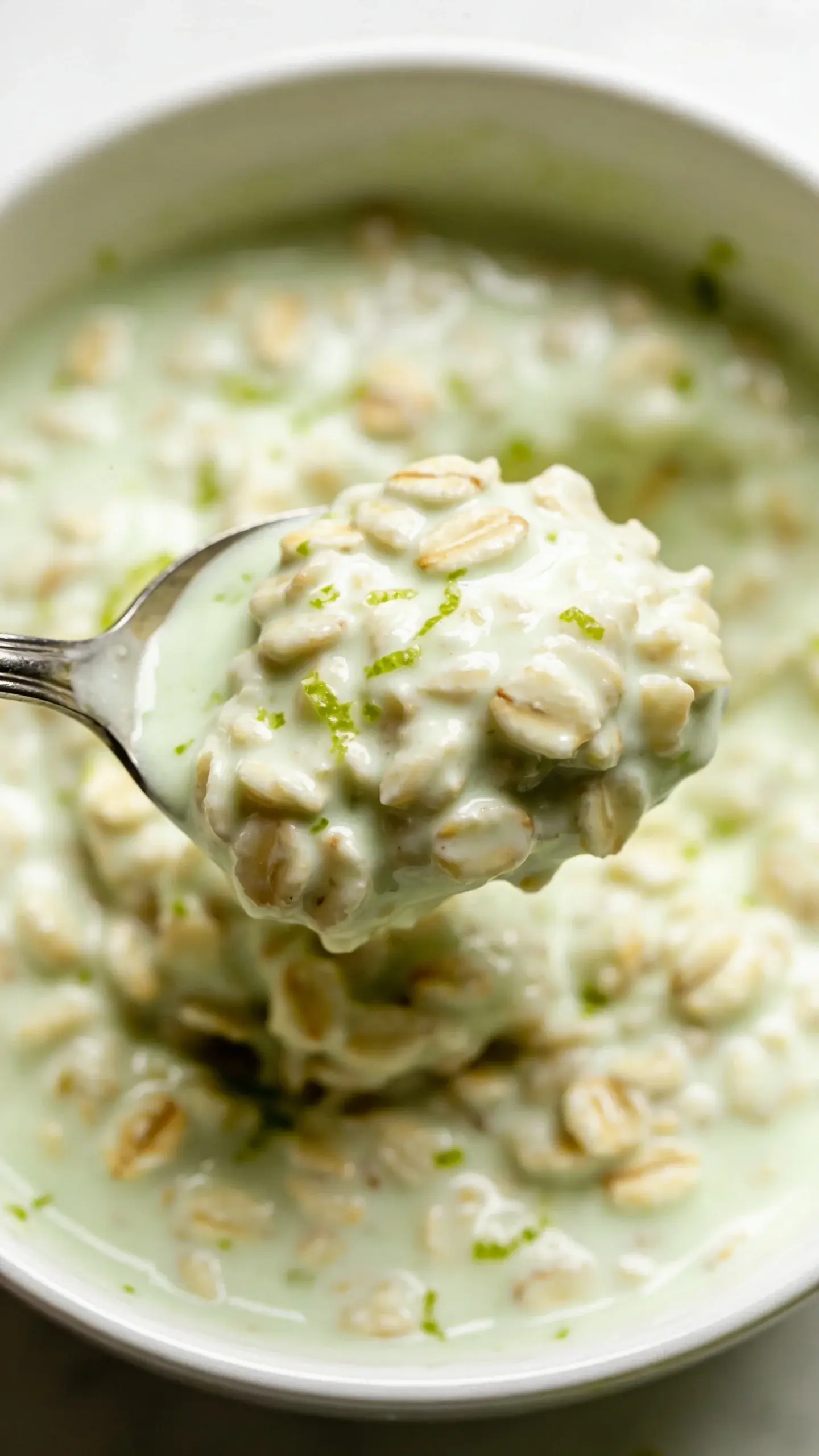 Spoonful of creamy key lime pie overnight oats above the jar