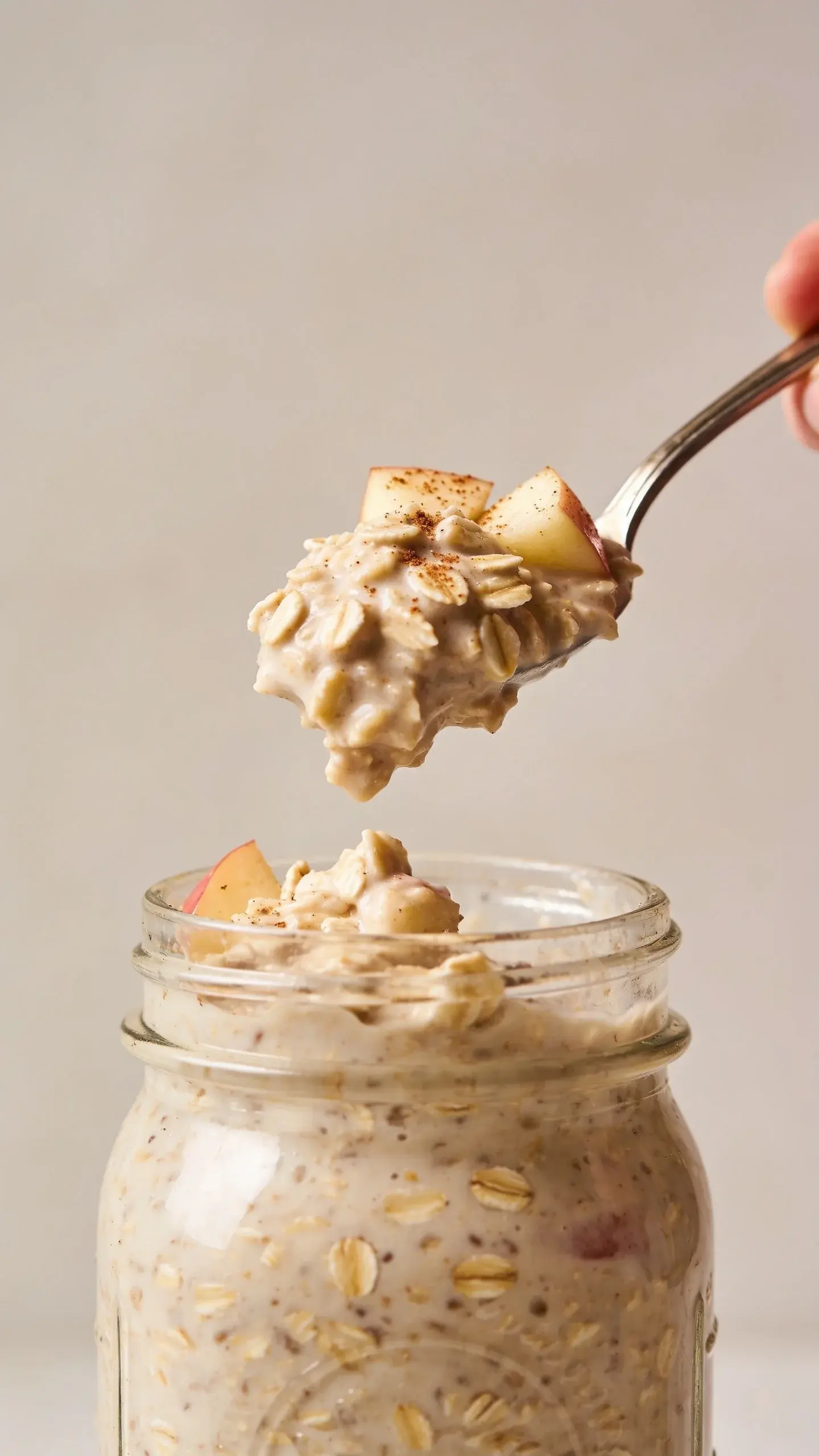 Spoonful of apple pie overnight oats above the jar