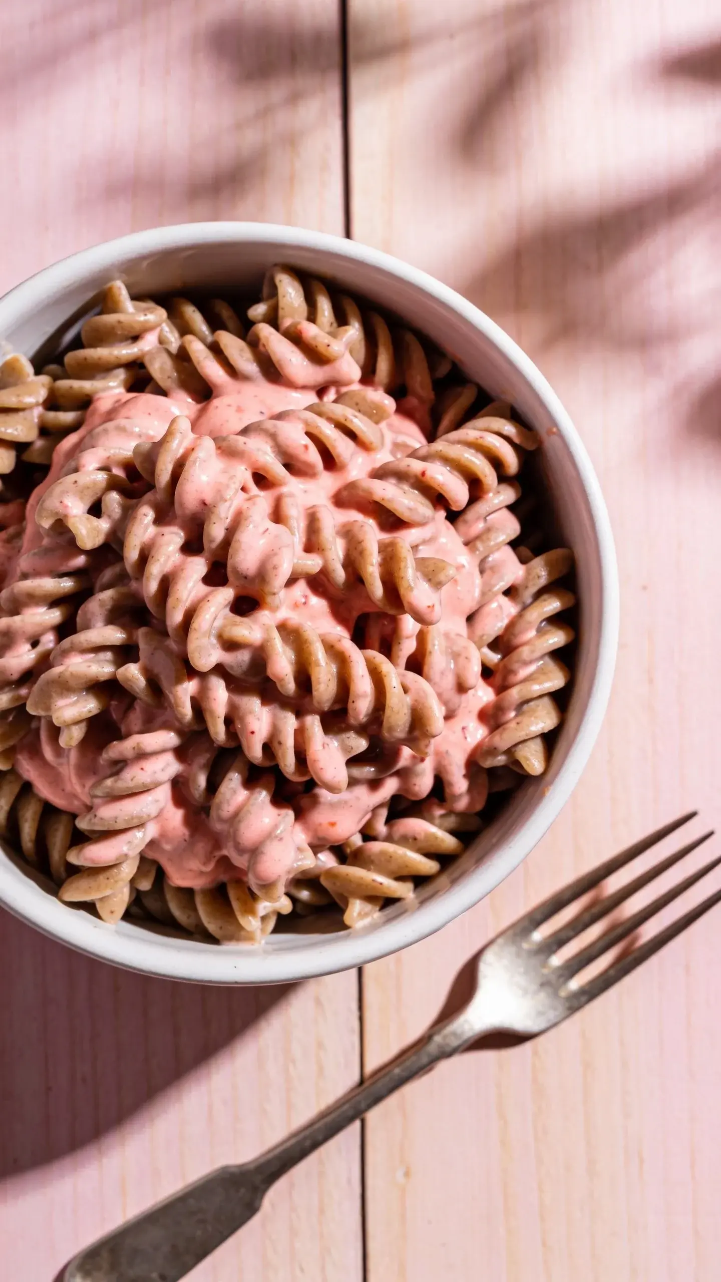 Bowl of pasta in a creamy pink tomato sauce with basil