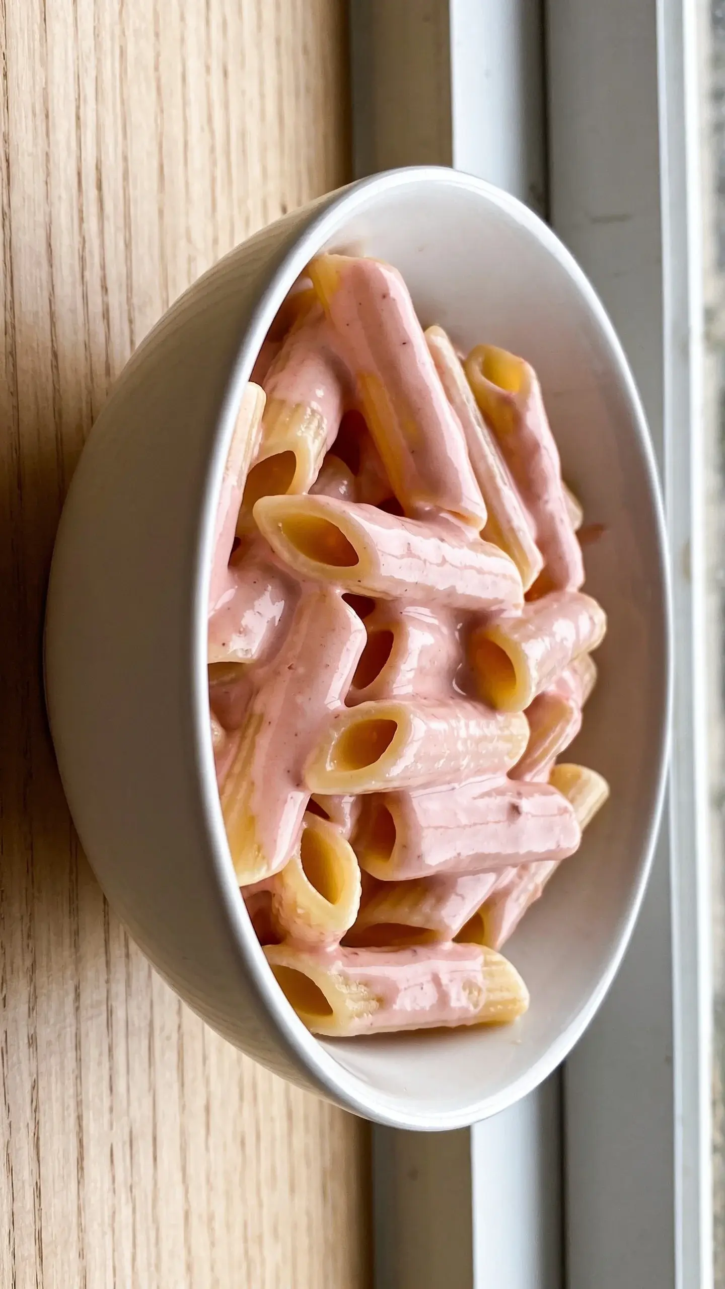 Bowl of penne in a creamy pink tomato sauce