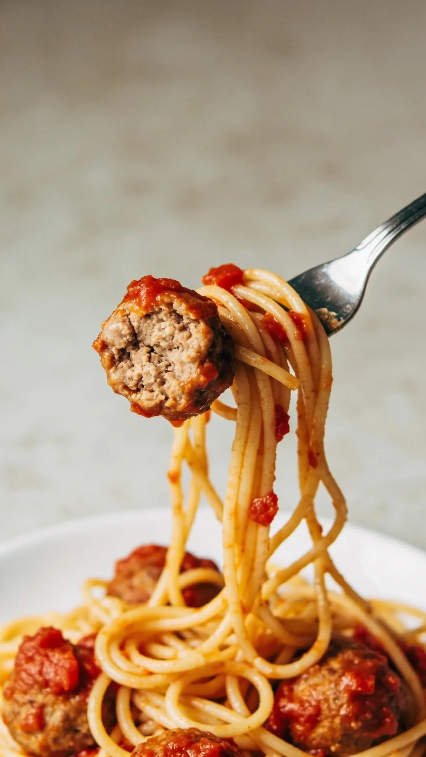 Close up of turkey meatballs on spaghetti with sauce